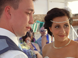 The bride and groom saying their wedding vows on the beach