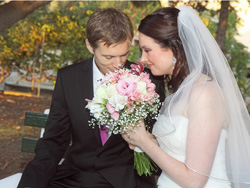 The bride and groom appriciating the bridal bouquet